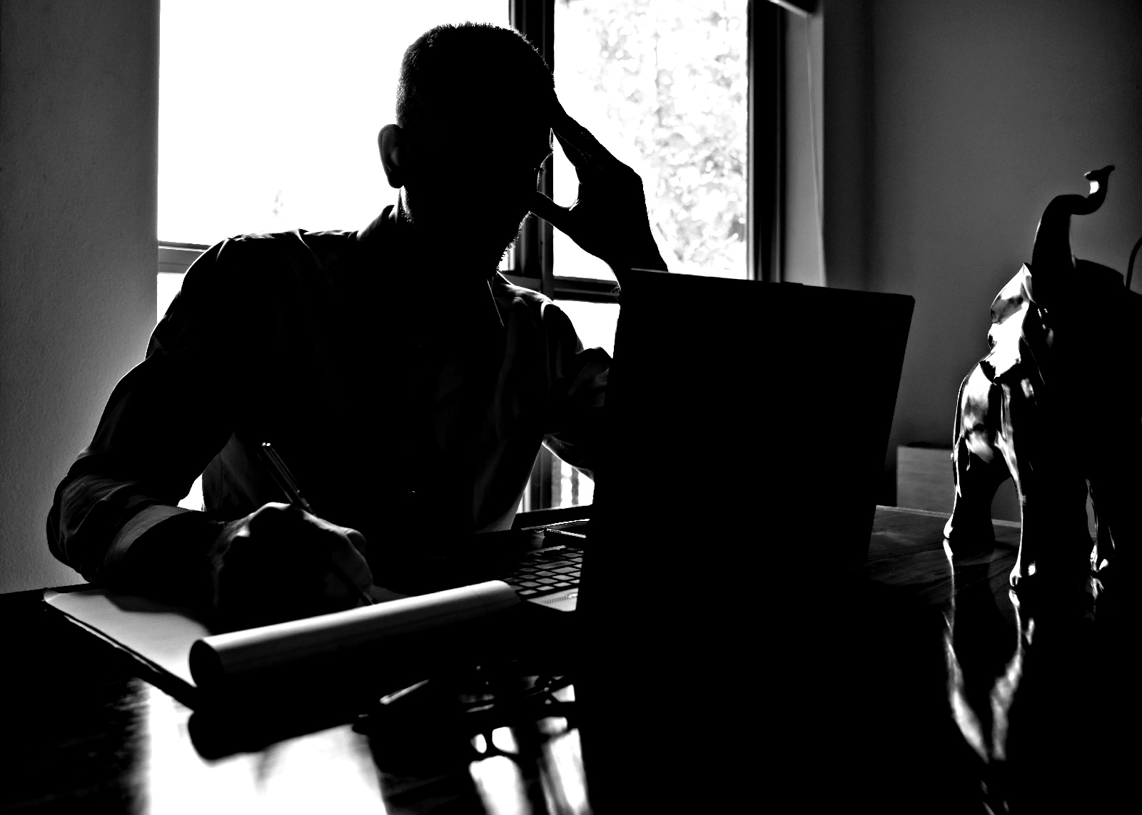 50701035-0-silhouetted-man-sitt